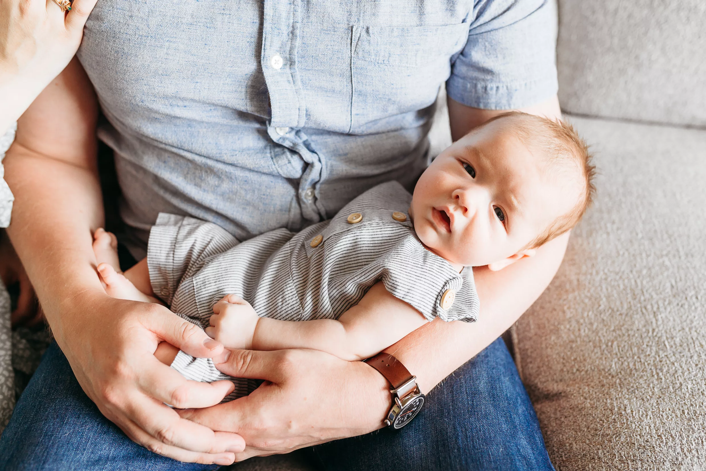 A toddler brother kisses his new baby sister during newborn photos.