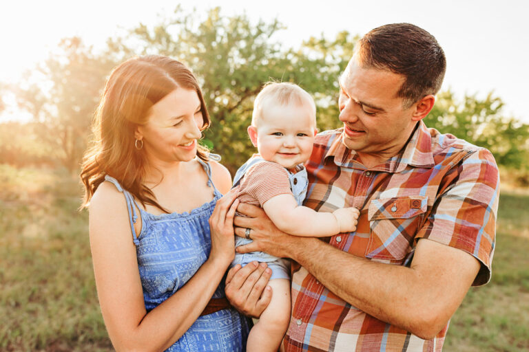 A young family gets their family photos taken at Lake Hefner in OKC.