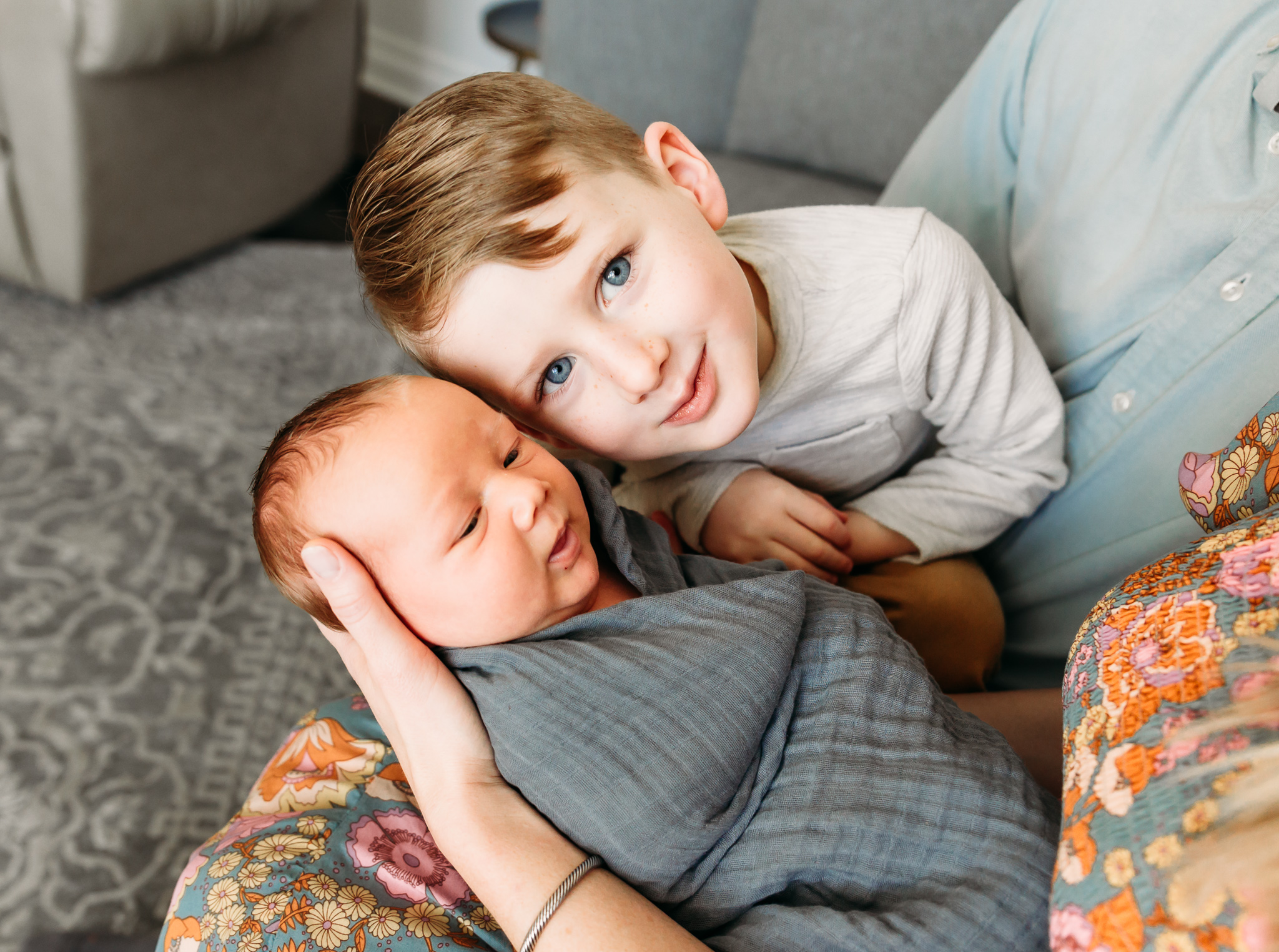 Big brother puts his face close to little brother.