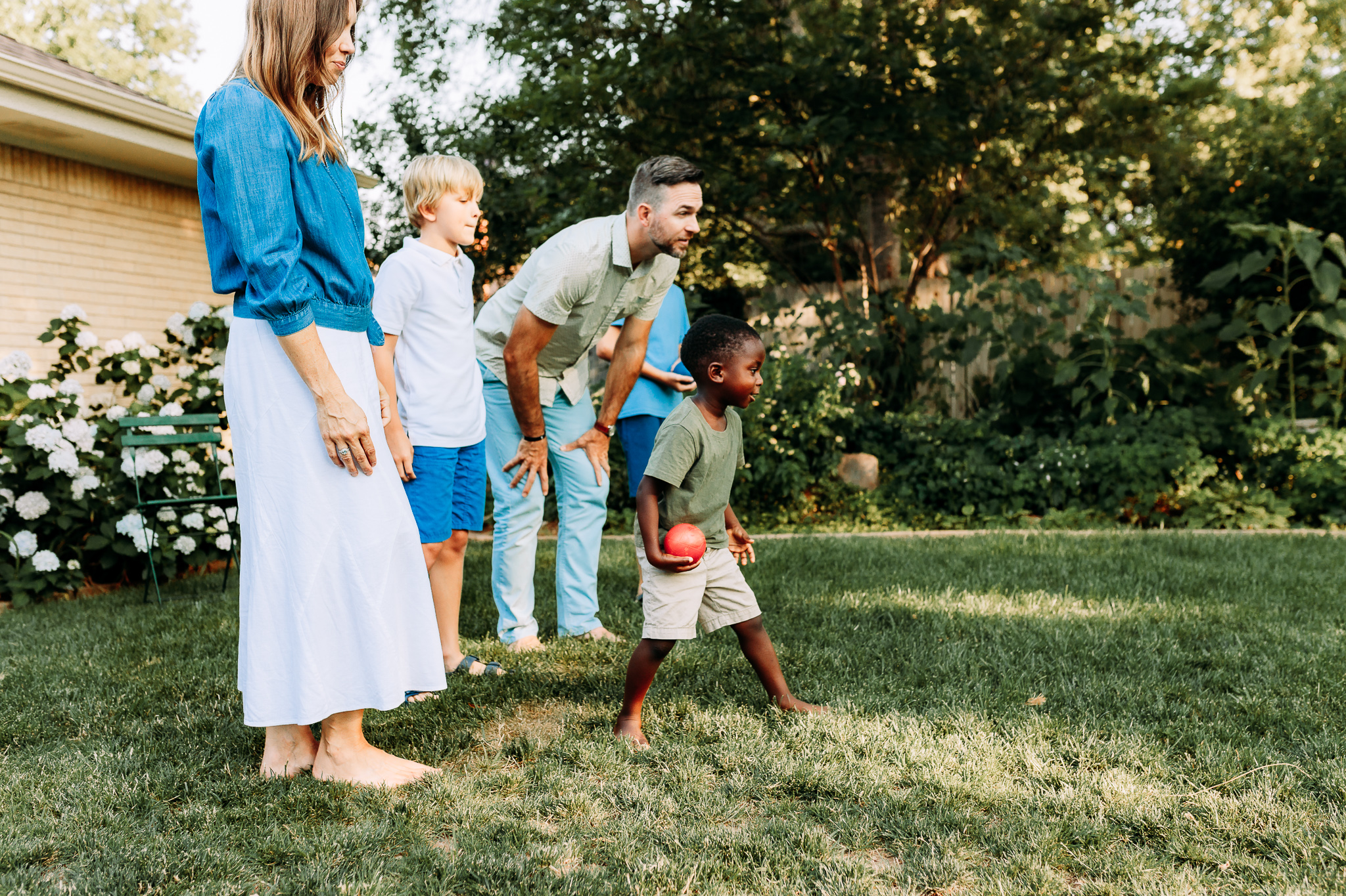 a family plays in their backyard.