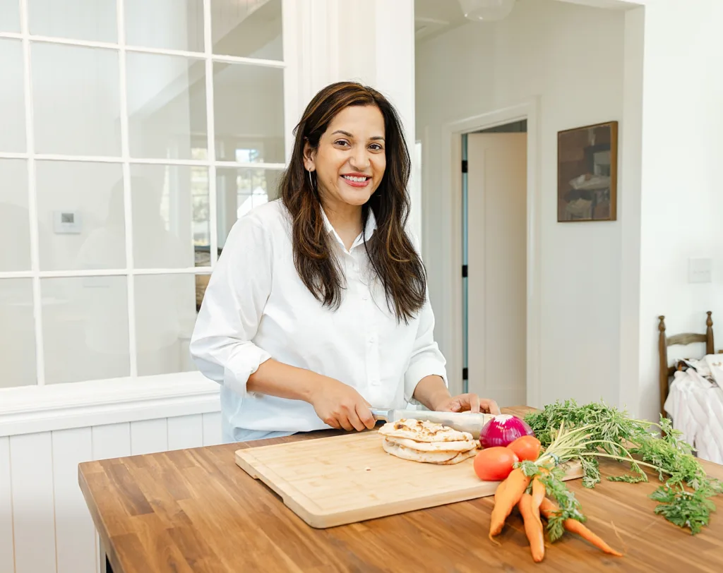 Amy stands int he kitchen to prep food for best okc postpartum doula