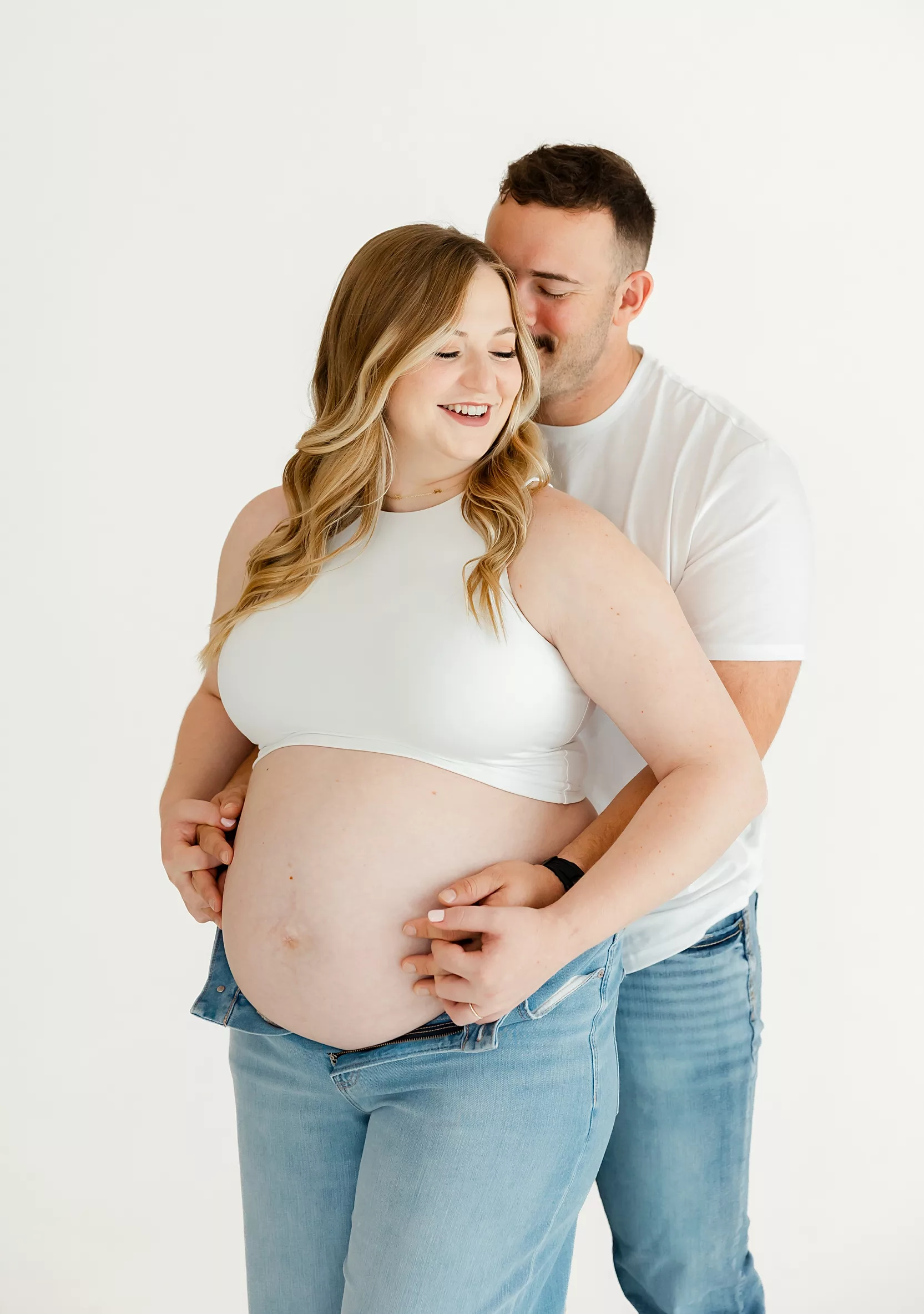 Expecting couple takes maternity photos and idea for maternity clothing stores in OKC.