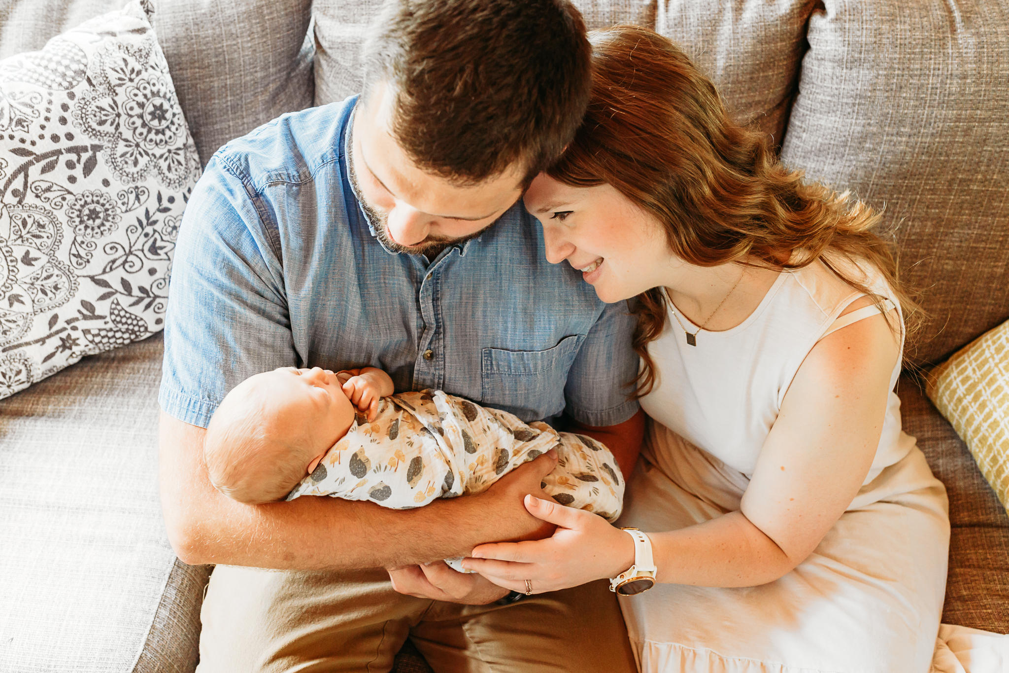 Mom and Dad gaze at daughter.