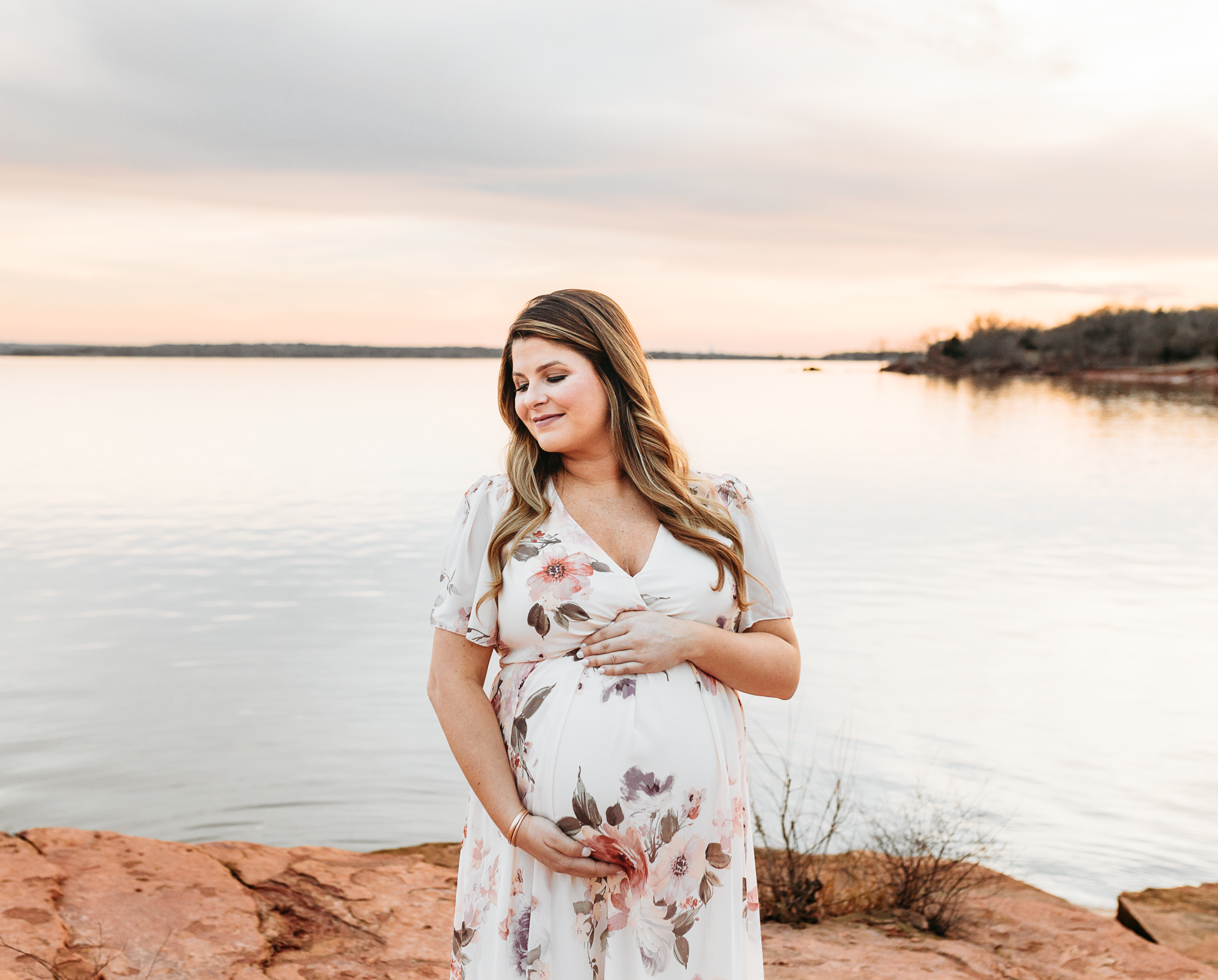 Pregnant mom at sunset at Lake Arcadia.