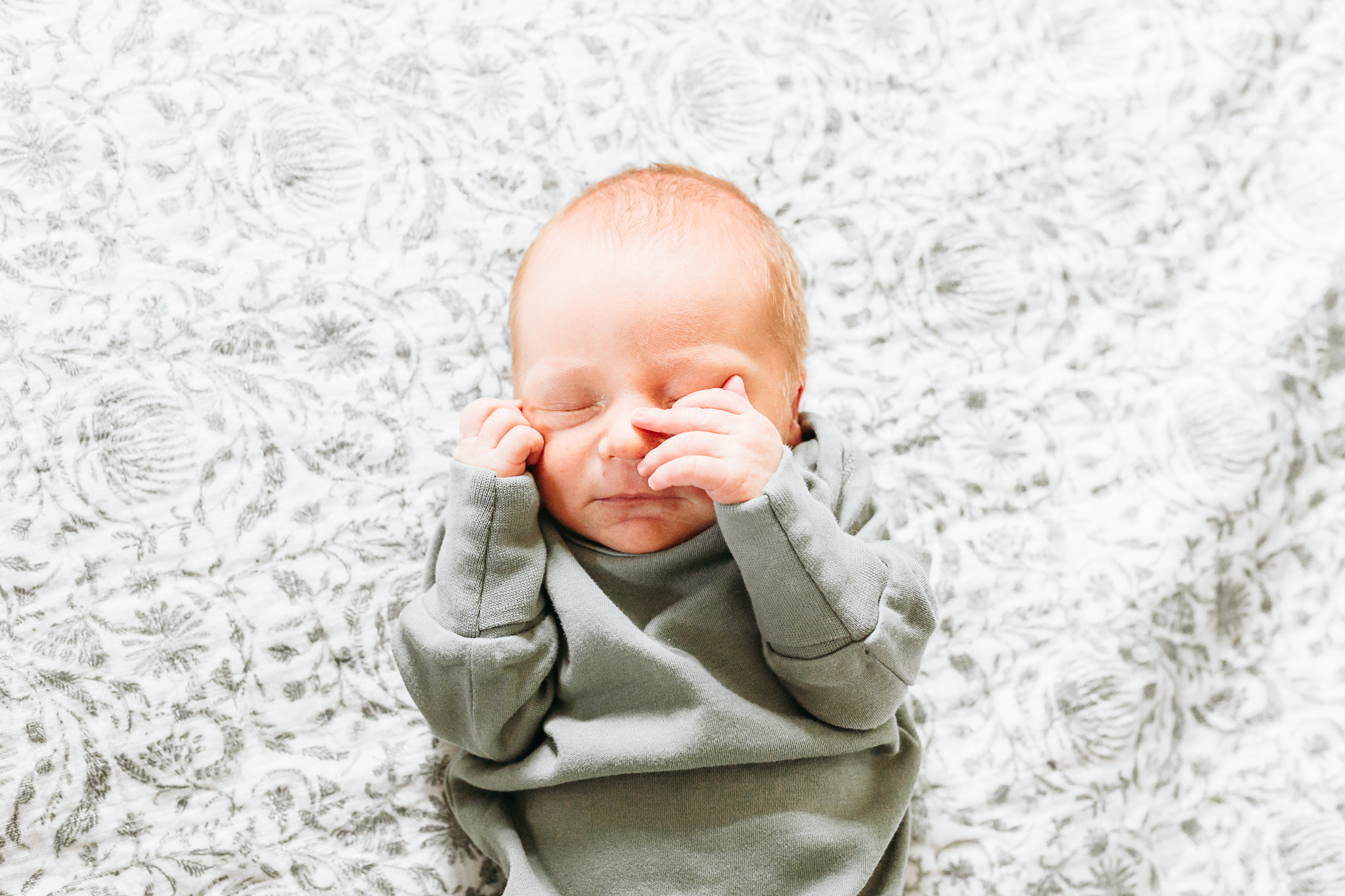 a mom and dad hold newborn during photo session