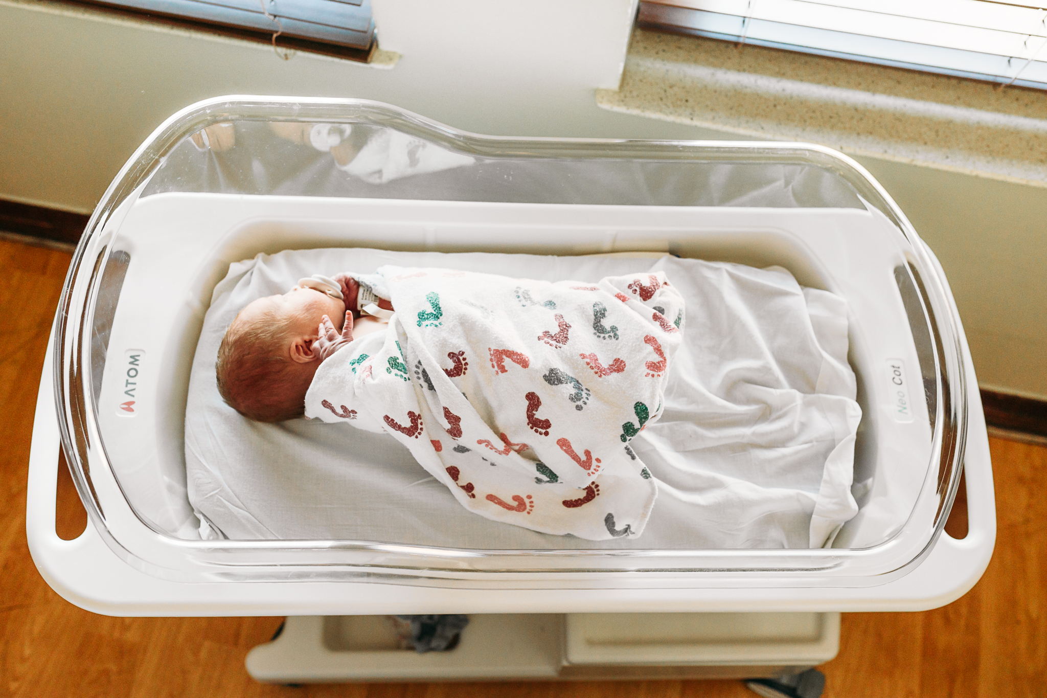 a mom and dad hold newborn during photo session