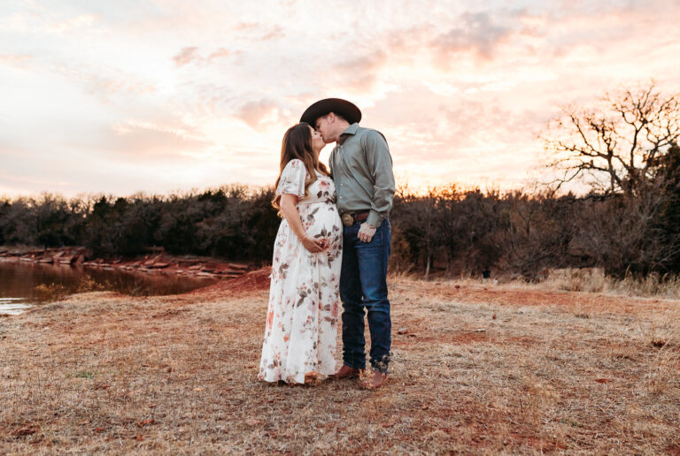 A couple stands in the sunset during their photo session at Lake Arcadia in Edmond, OK.