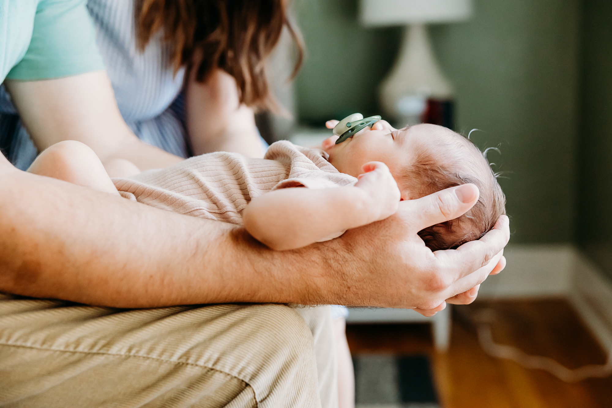 Baby lays in Daddy's arms.