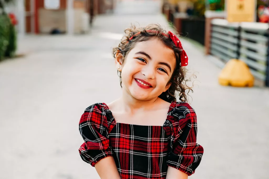 Young girl smiles during family photos.