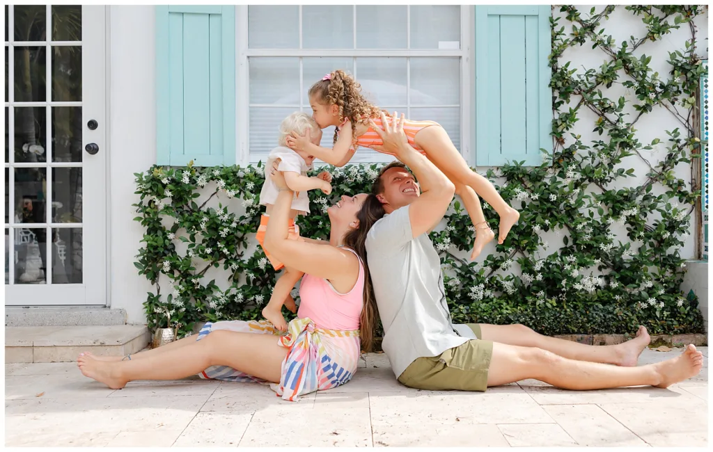 family of 4 outside of pool during a family poolside session.