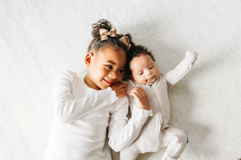 A big sister with her newborn brother.