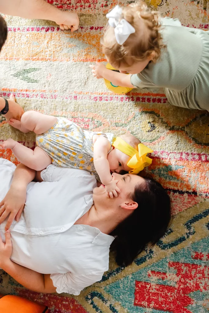 A family plays in the light in their living room.