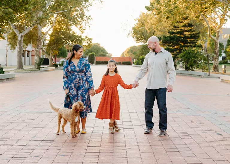 Family of 3 with goldendoodle during fall family photos in downtown OKC.