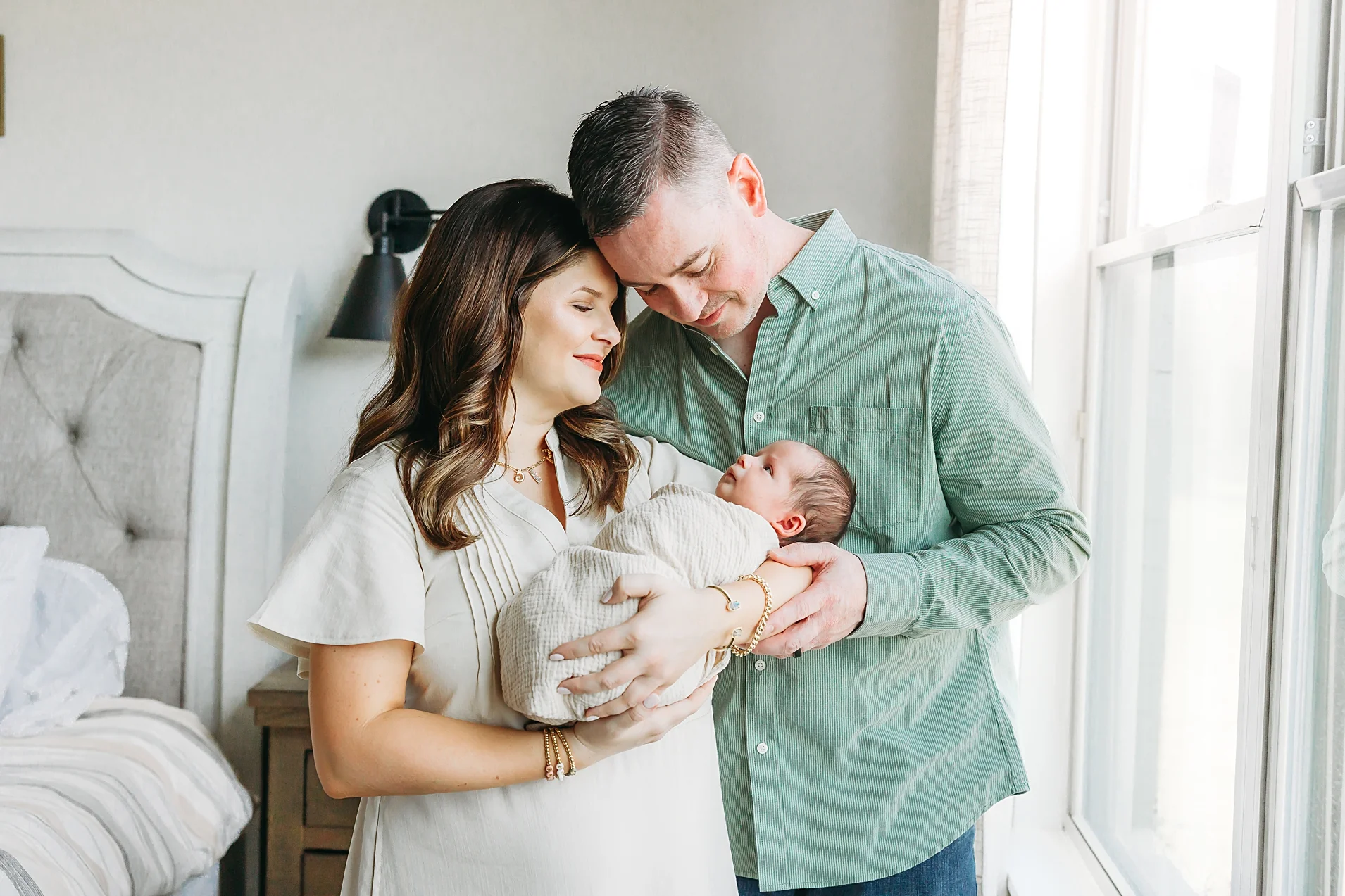 Couple stands together with newborn during OKC newborn photo sessions.
