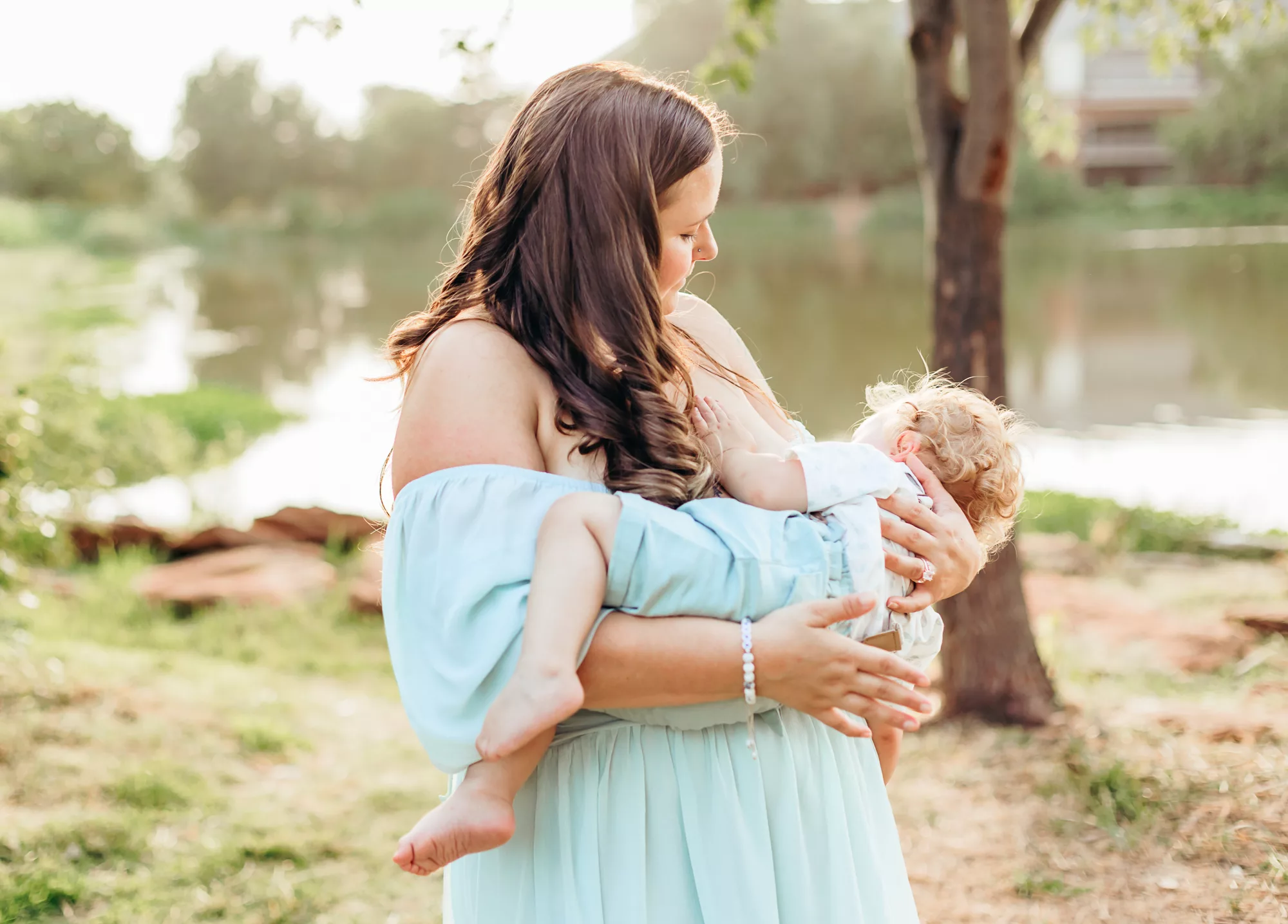 a mom nursing her little one at an OKC breastfeeding mini session.