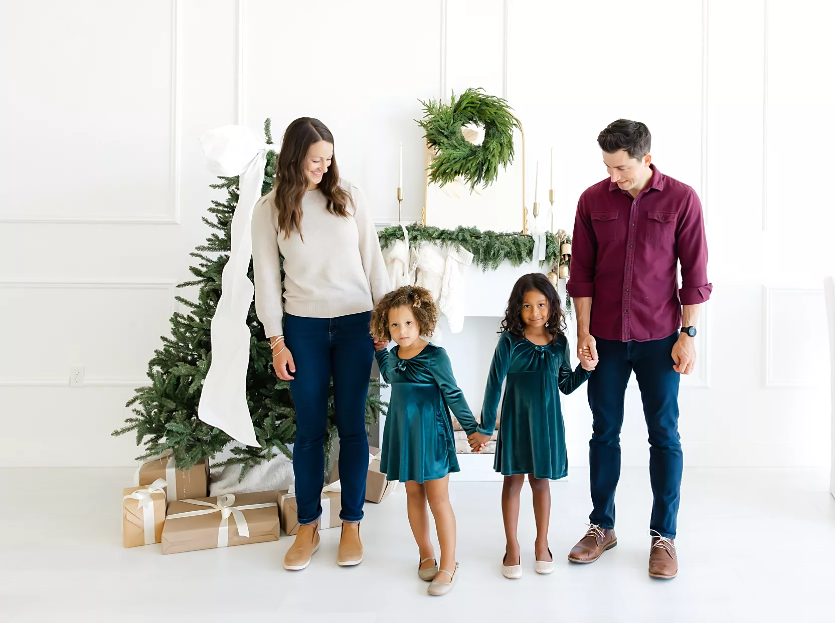 Mom and son sit in front of Christmas Trees in Edmond, OK studio.