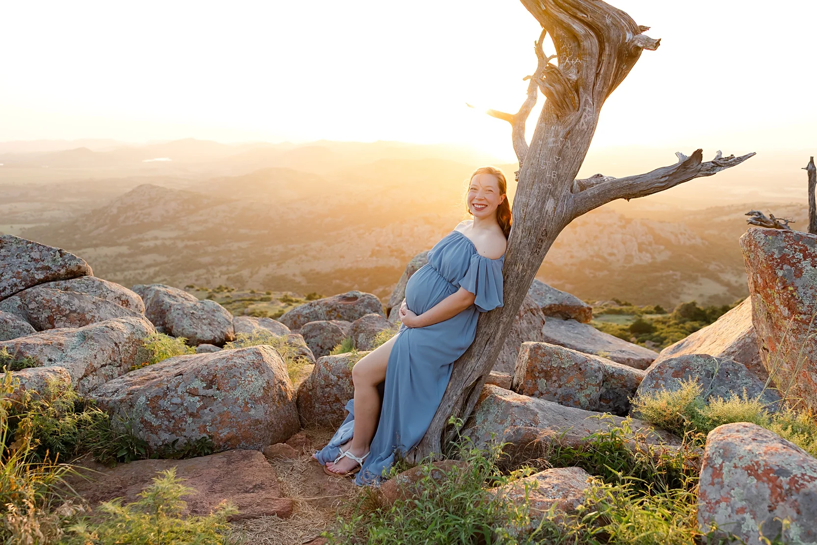 Mom and Dad in white shirts hold baby during newborn photoshoot.