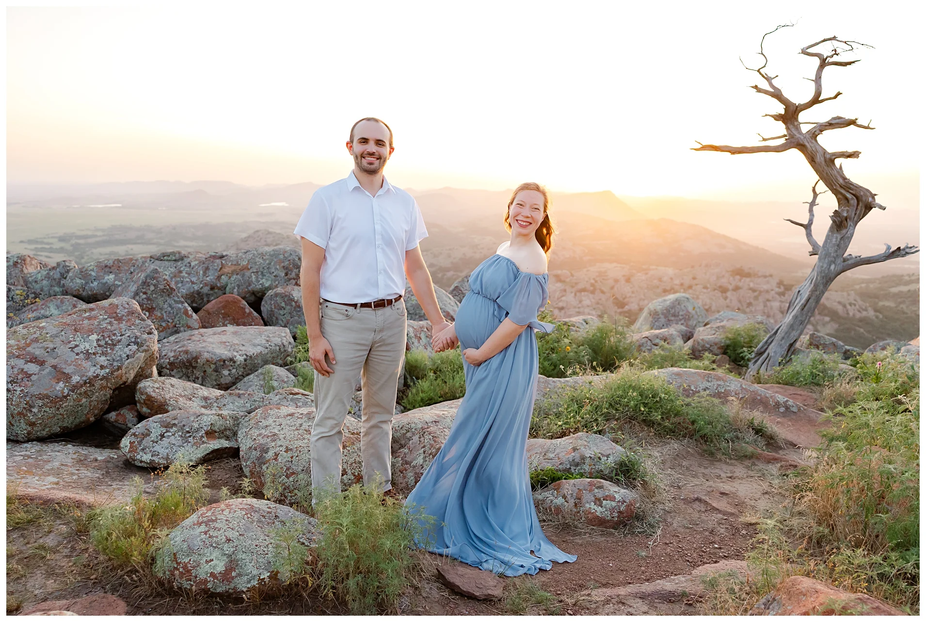 Mom and Dad in white shirts hold baby during newborn photoshoot.