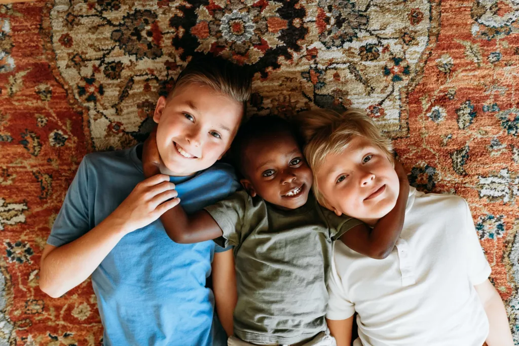 3 brothers hug on the floor during family photos at home in Oklahoma City.