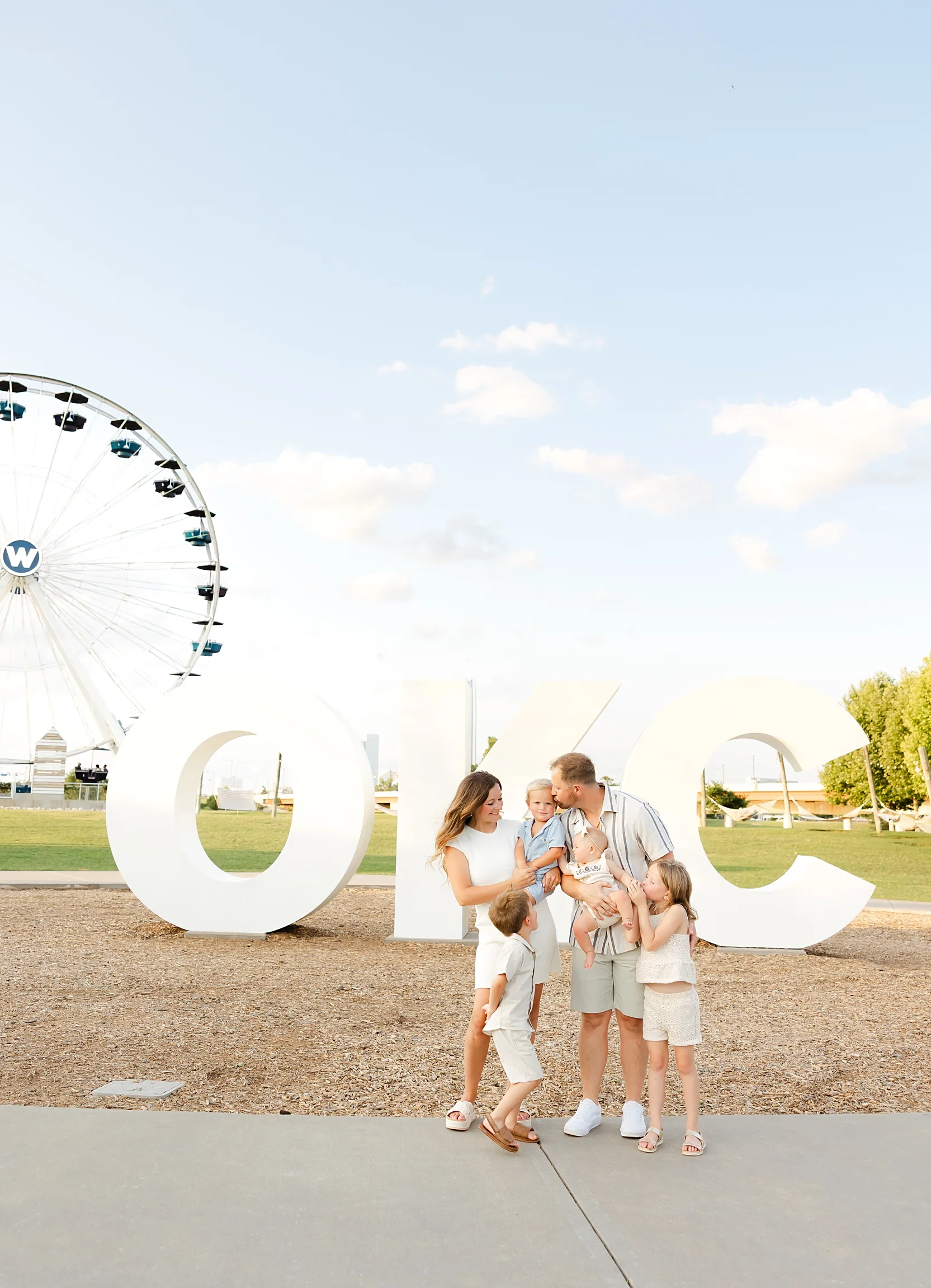 Family of 6 in front of OKC sign at Wheeler District.