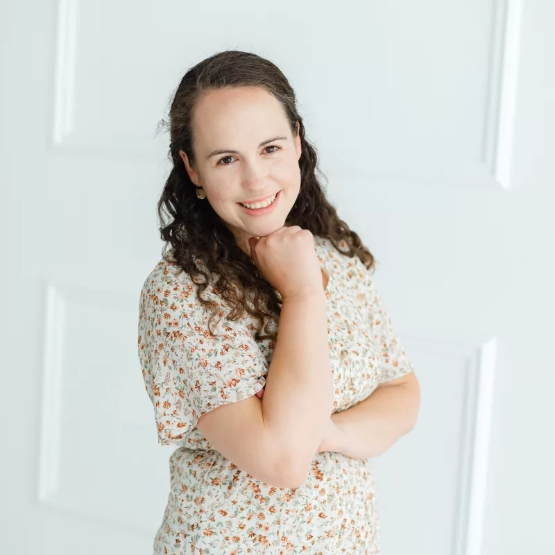 Charis, Oklahoma City Family Photographer, standing in a floral cream dress on white background