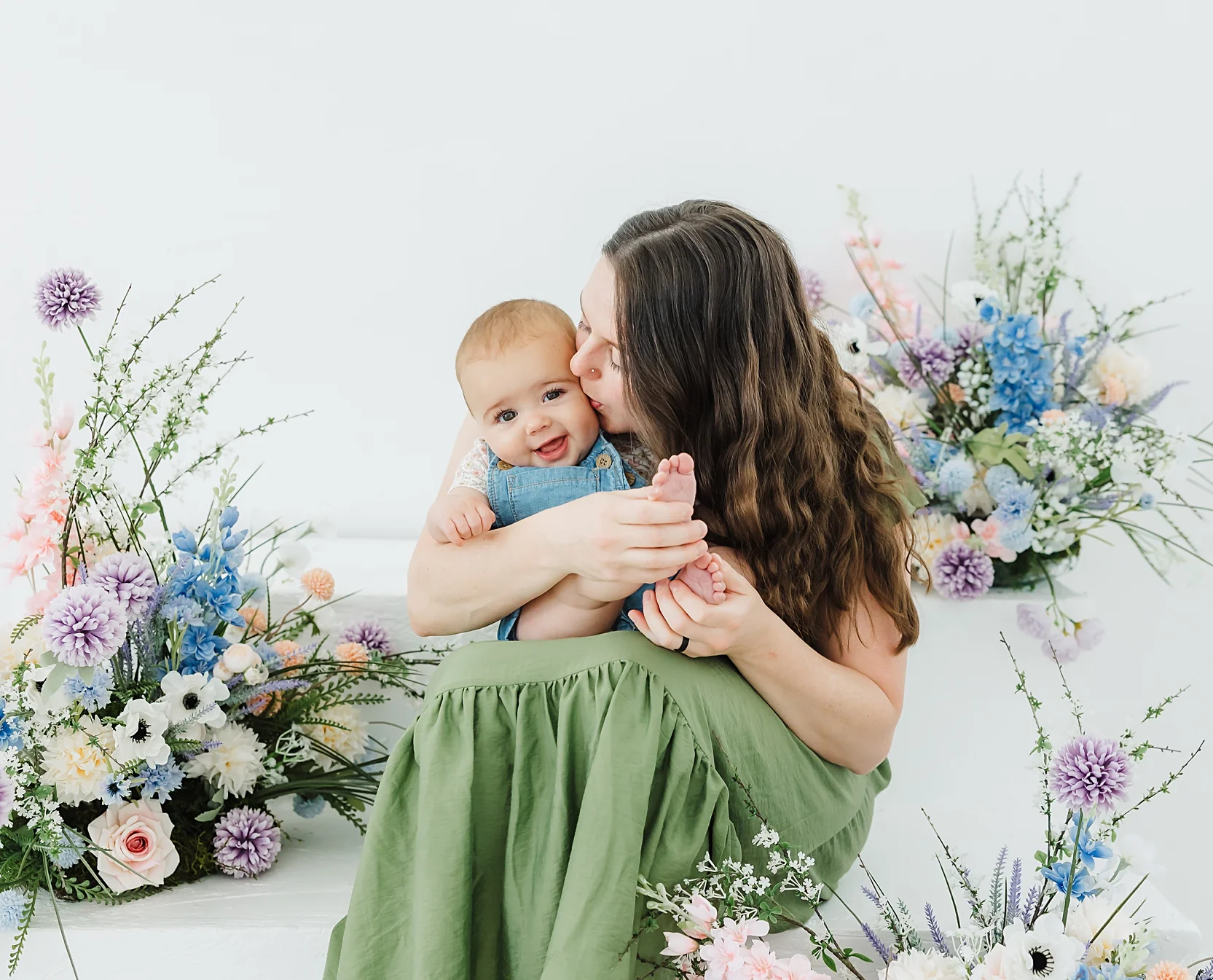 Mother kisses her daughter during photos at OKC Ren Studio.