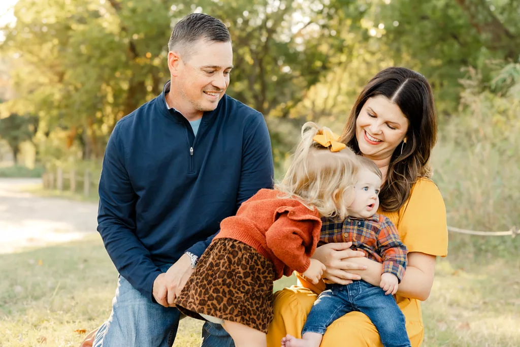 Family laughs together during their fall amily photos.