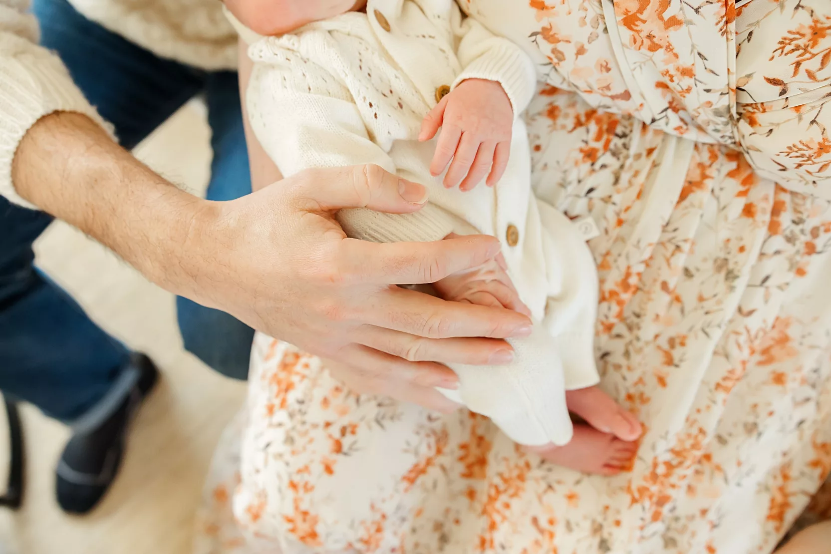A photo of a baby's hand in sharing how to respect privacy in family photos for families. 