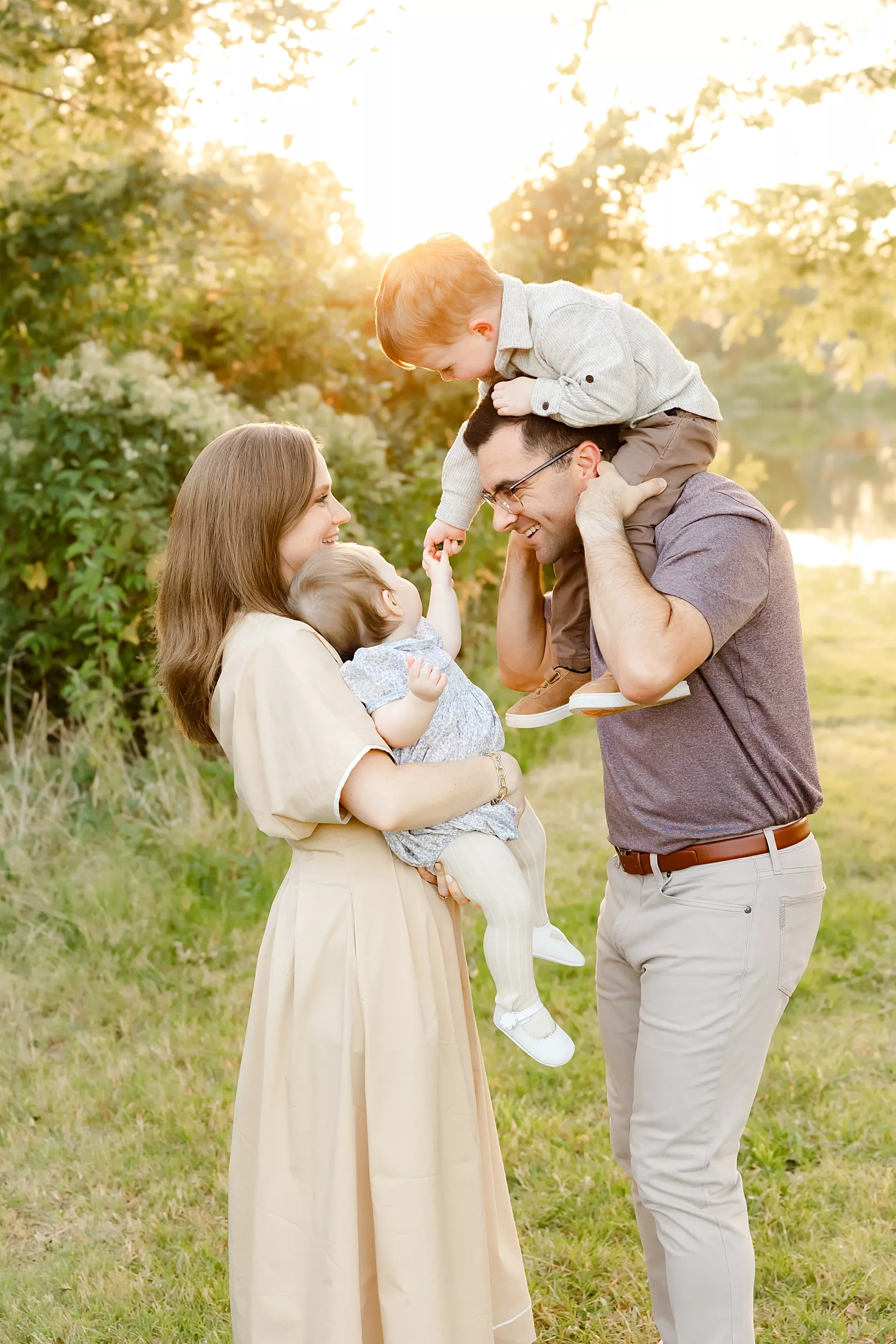 family of 4 during newborn photo session with overlay saying newborn on it.
