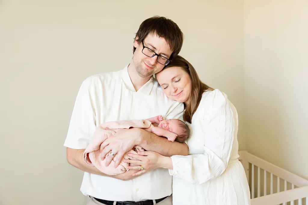 Dad and Mom snuggle with new baby during Oklahoma City Newborn Photography.