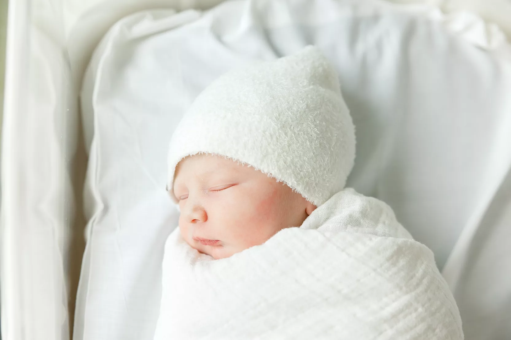 Dad kisses is son during an in hospital baby photo session.