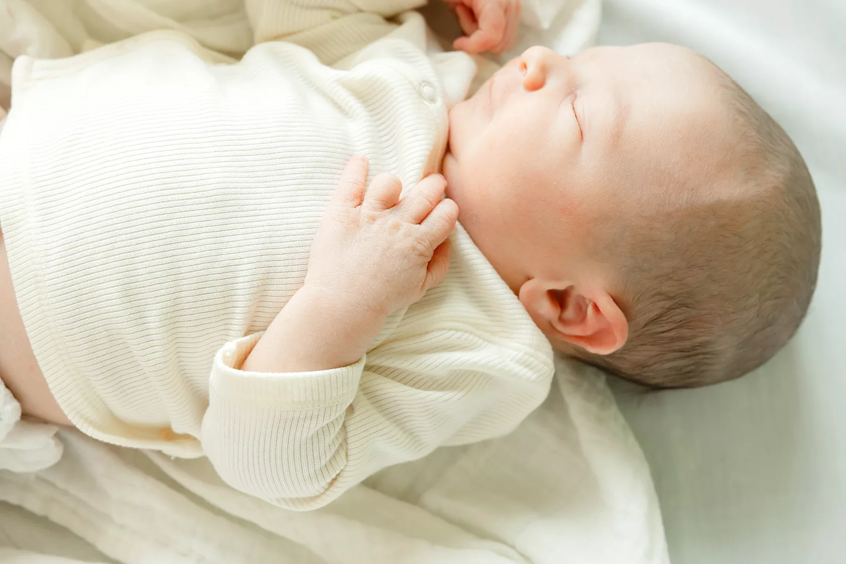 family of 4 during newborn photo session with overlay saying newborn on it.