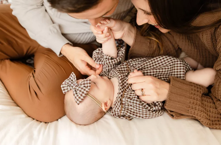 parents play with 3 month old for family photos in OKC.