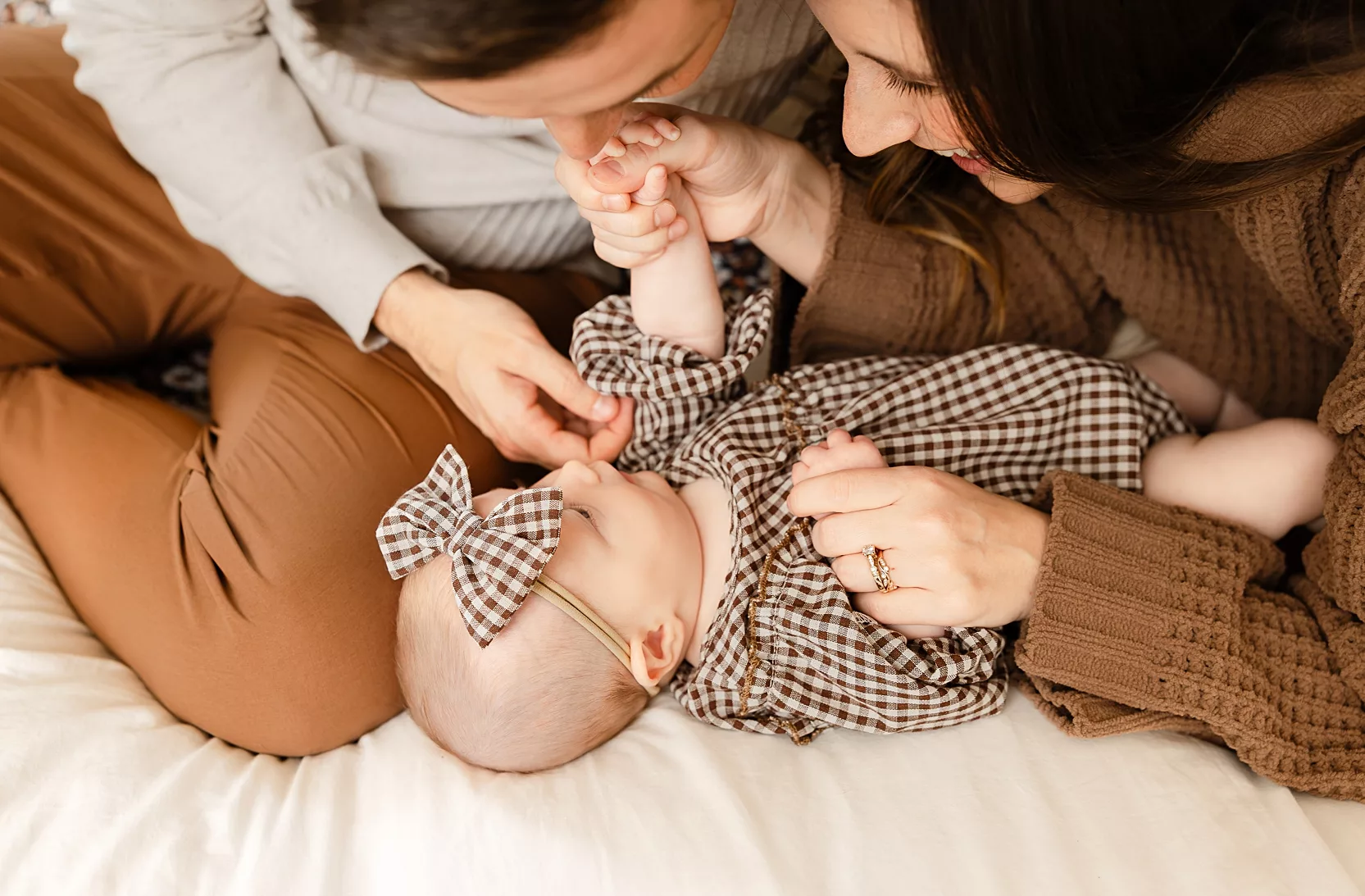 parents play with 3 month old for family photos in OKC.