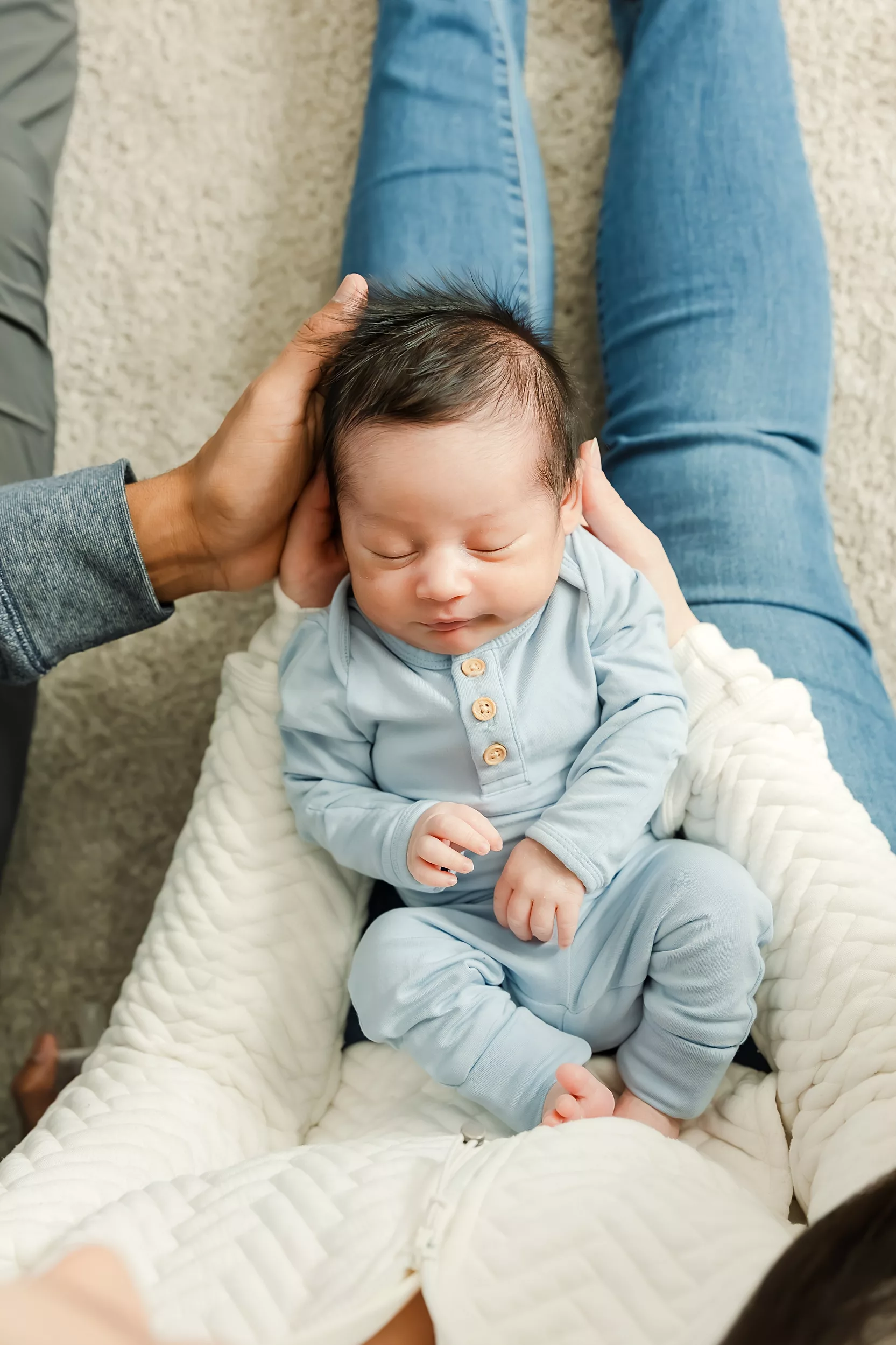 Dad kisses is son during an in hospital baby photo session.