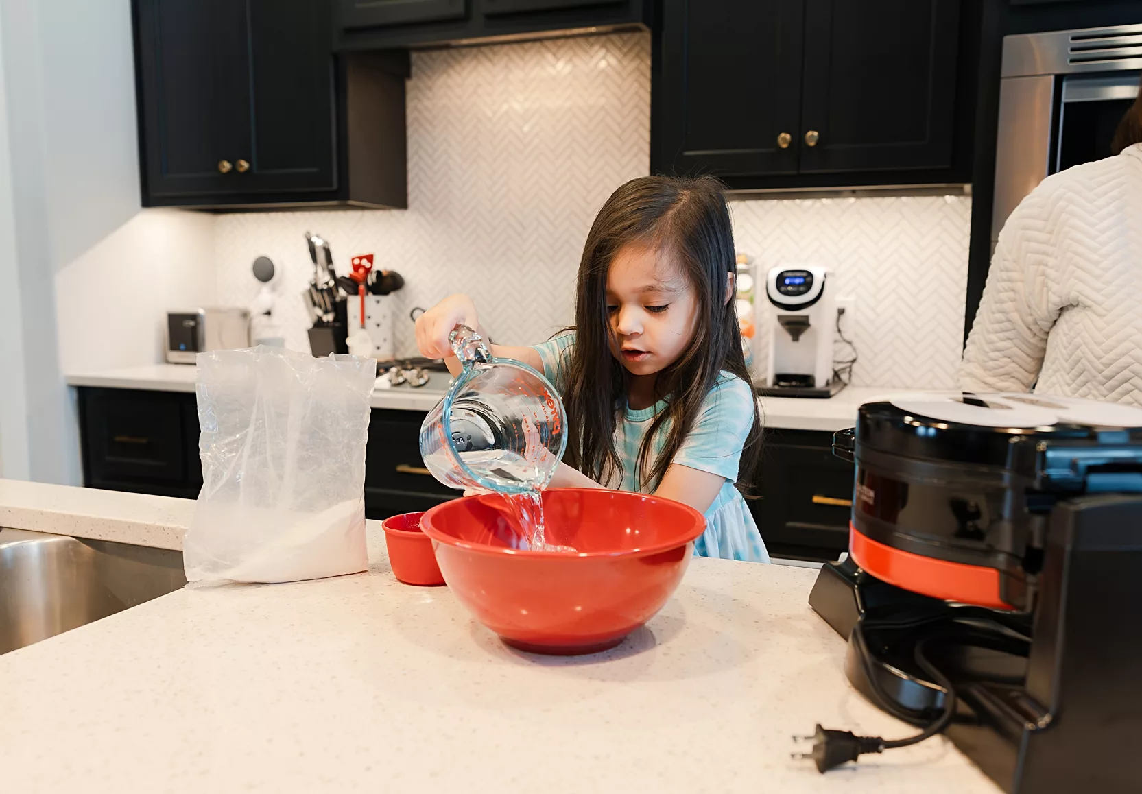 making waffles during. athome newborn photos in Edmond OK.