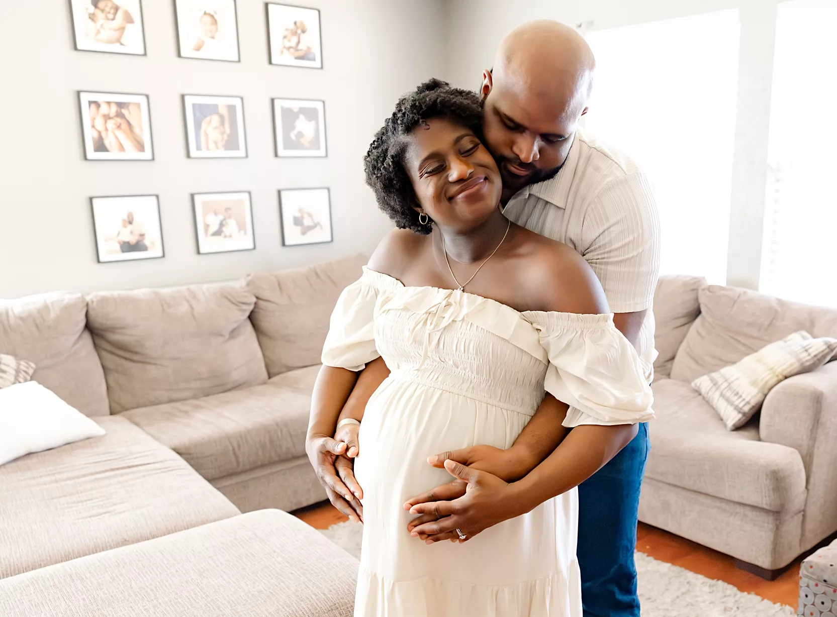 family of 3 plays on bed during in home family photo session