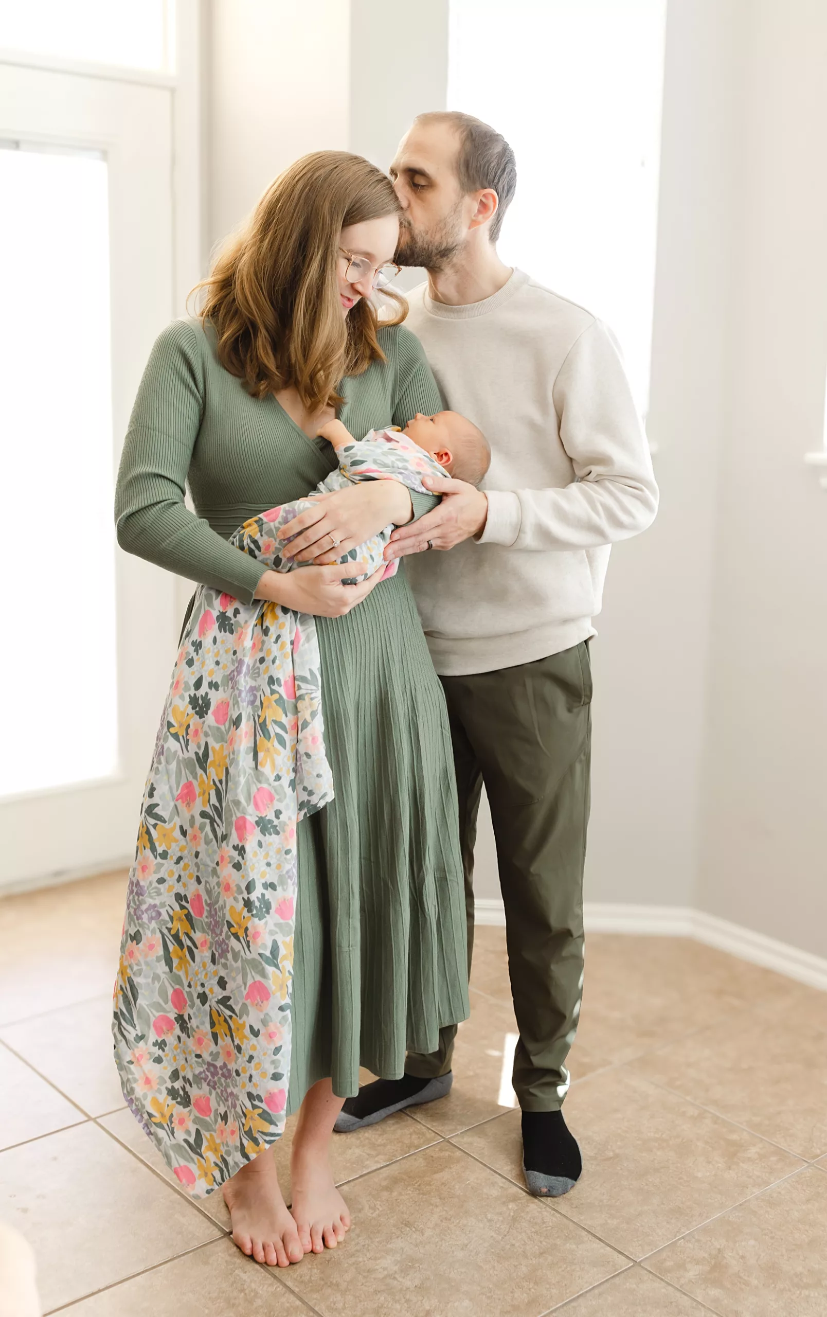 Dad kisses is son during an in hospital baby photo session.