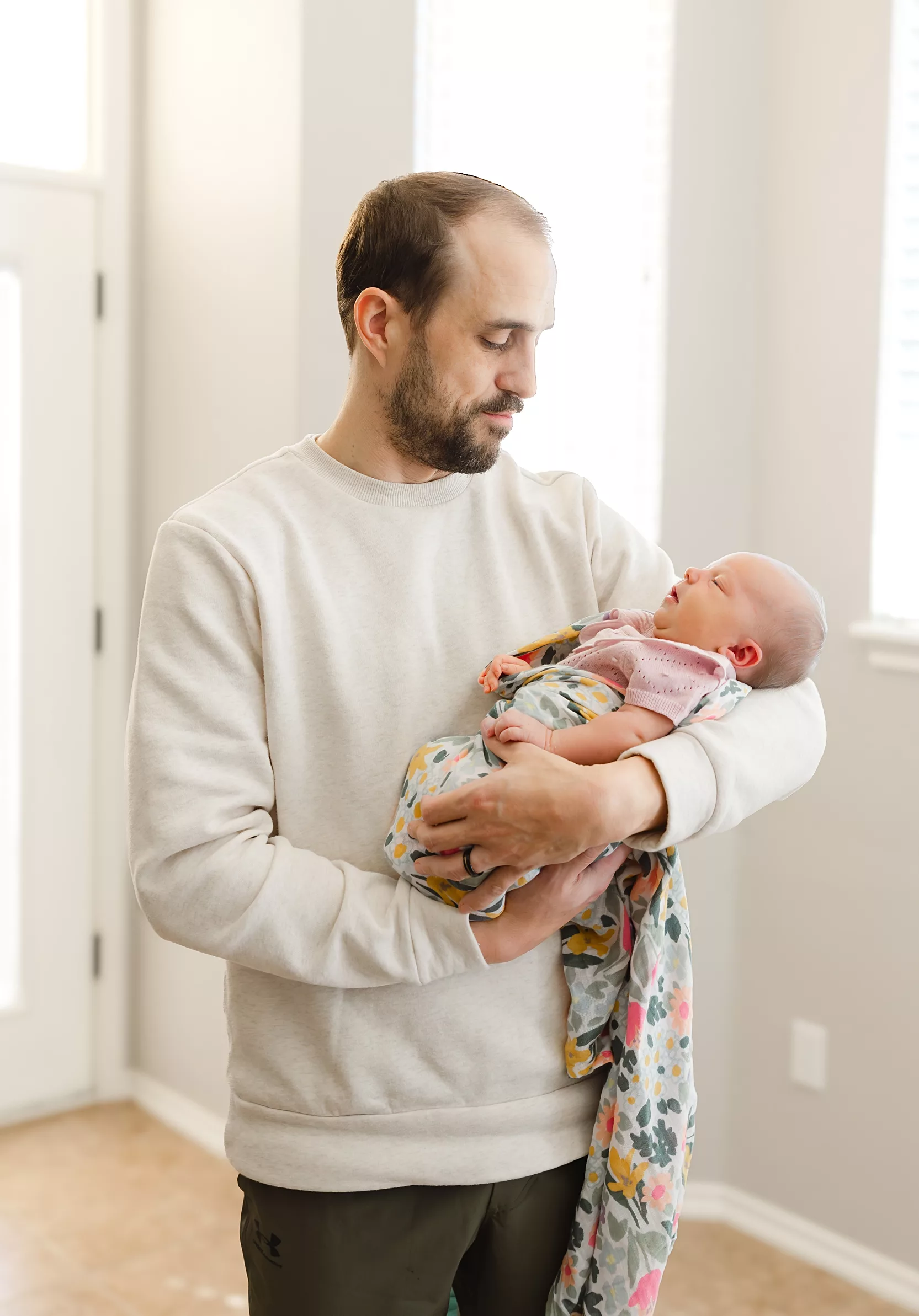 New baby lies in a hospital crib during a oklahoma city Fresh 48 photography session.