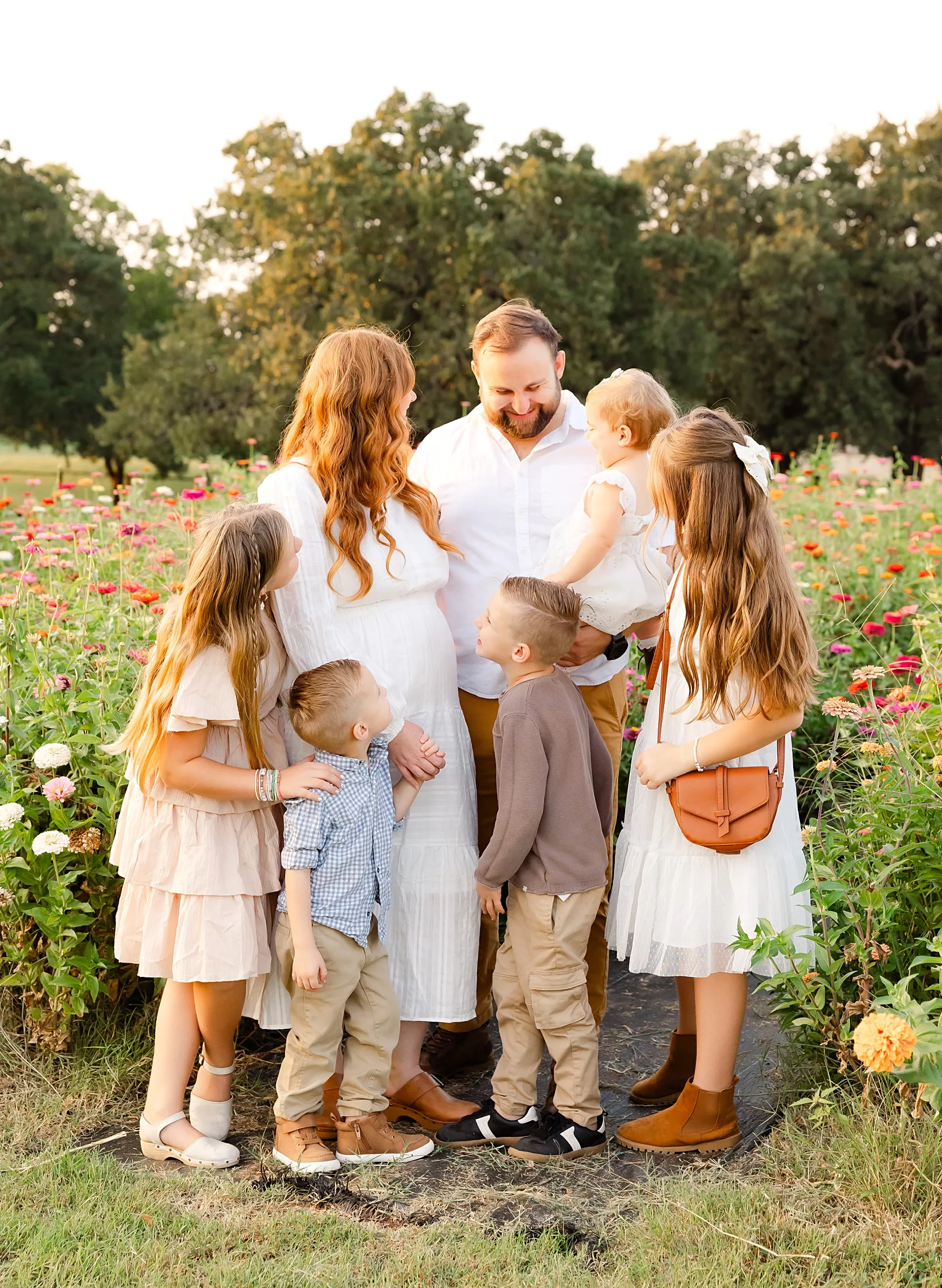 family of 4 during newborn photo session with overlay saying newborn on it.