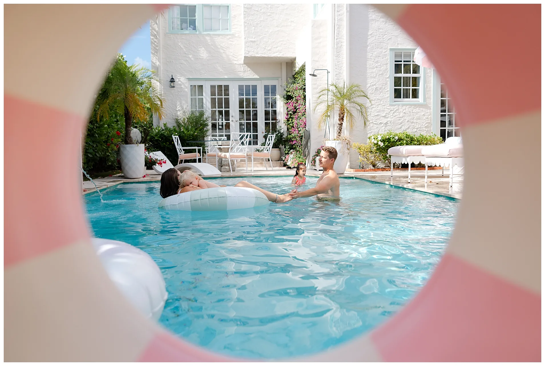 family of 4 plays together during a summer pool session.