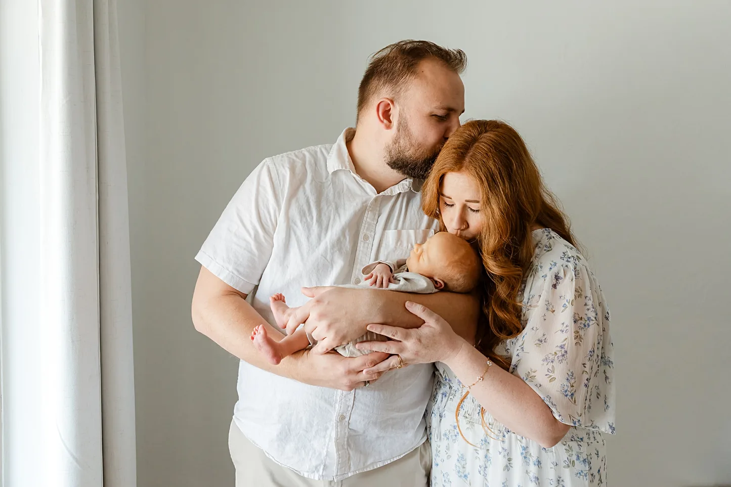 Mom and Dad together during their baby boys newborn photos.