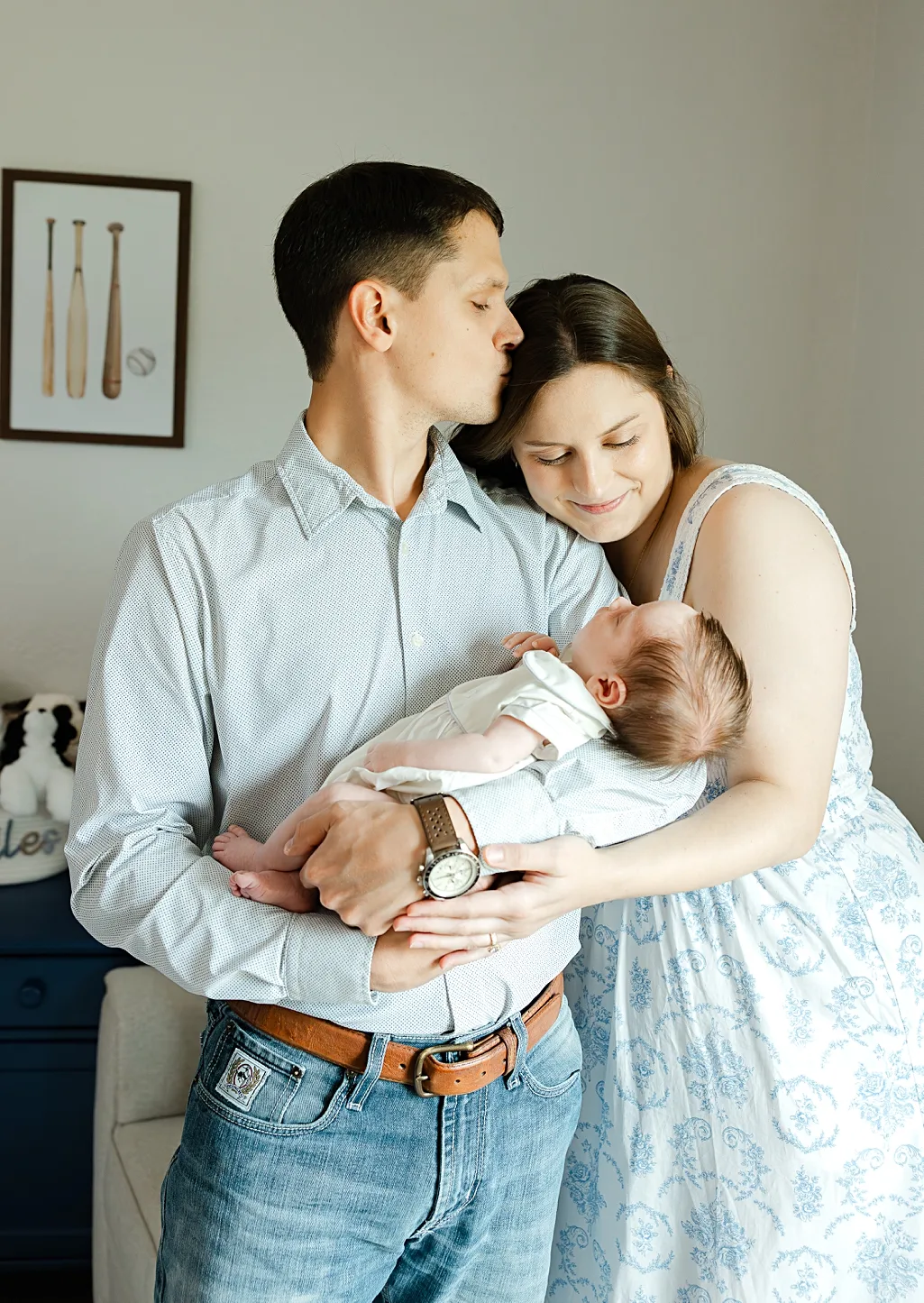 family of 4 during newborn photo session with overlay saying newborn on it.
