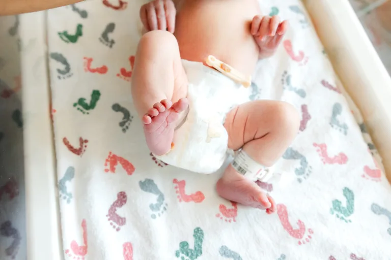 tiny little baby toes in hospital bassinet.