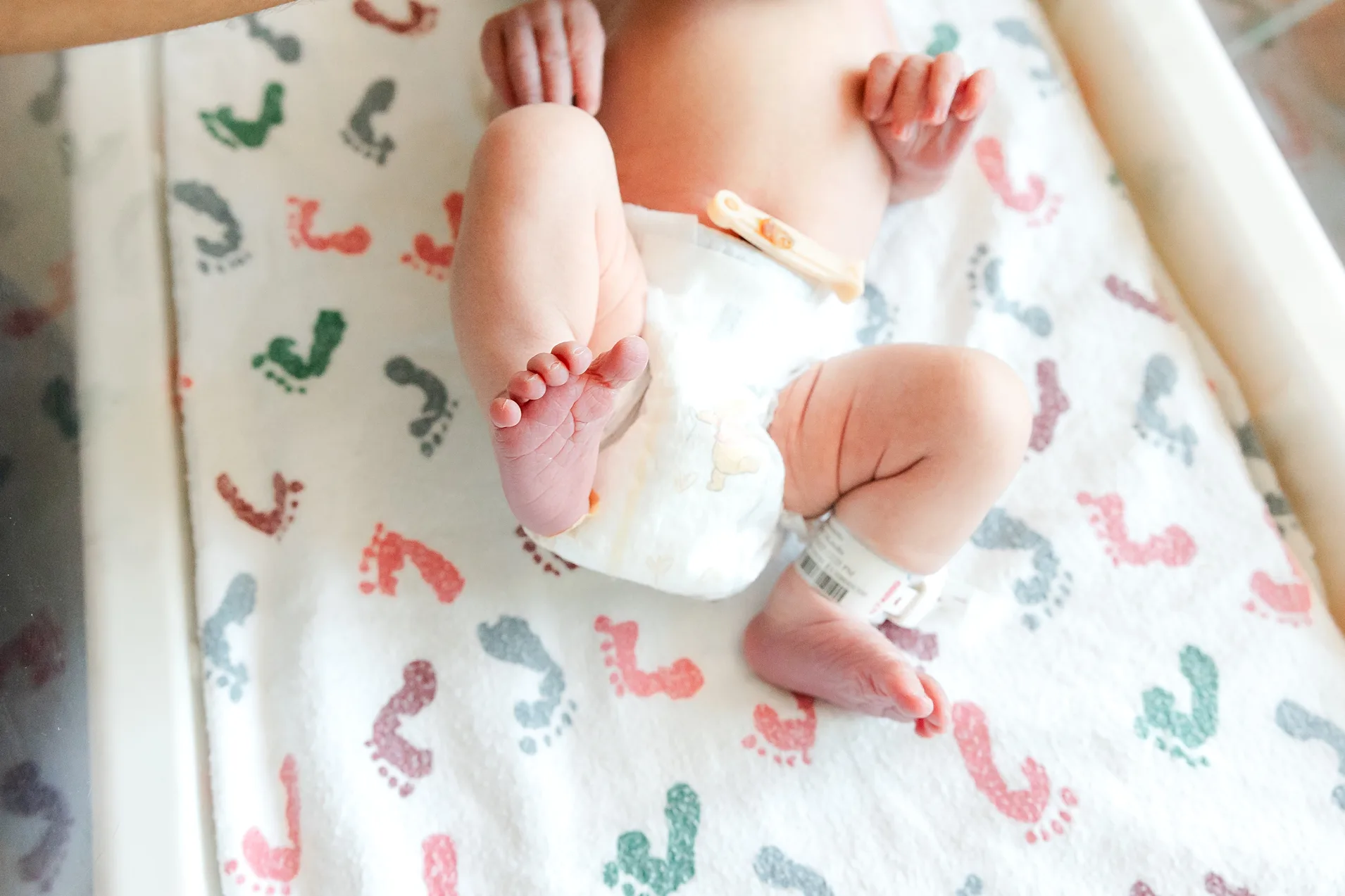 tiny little baby toes in hospital bassinet.