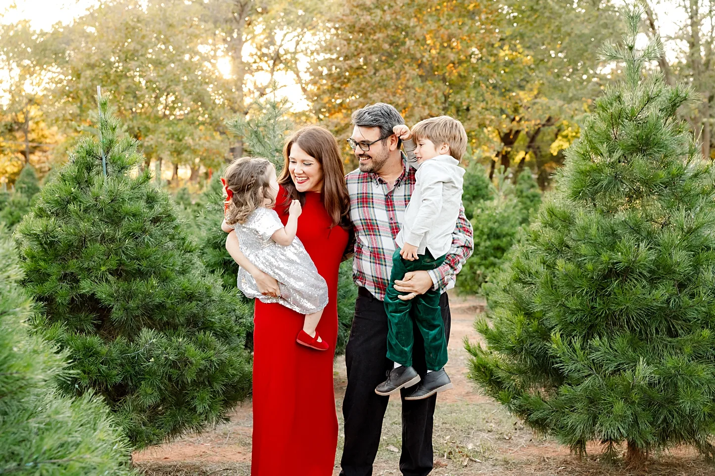 family of 4 at the a Christmas Tree Farm Mini Session in Norman, OK.