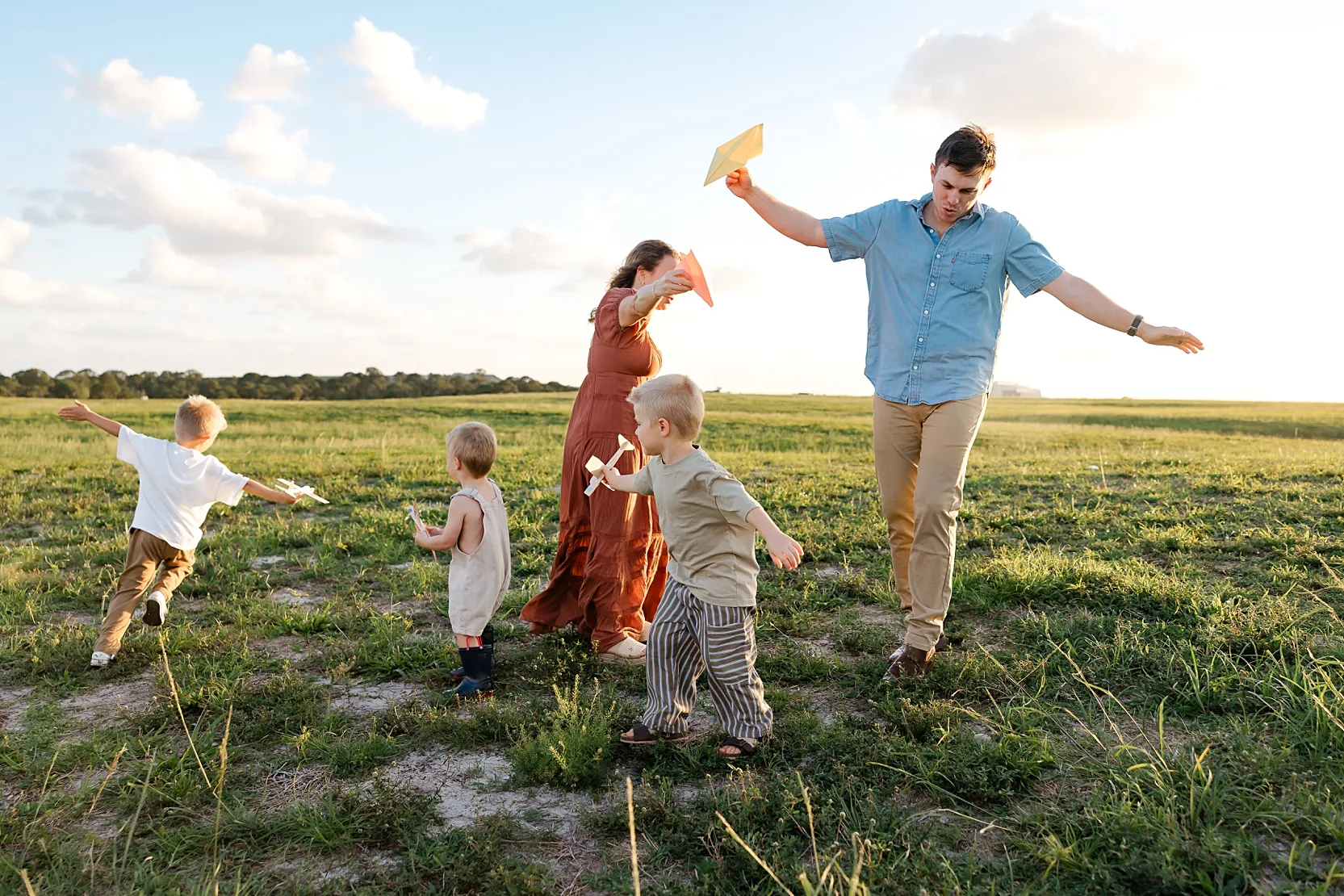 A family plays in their backyard on a summer evening.