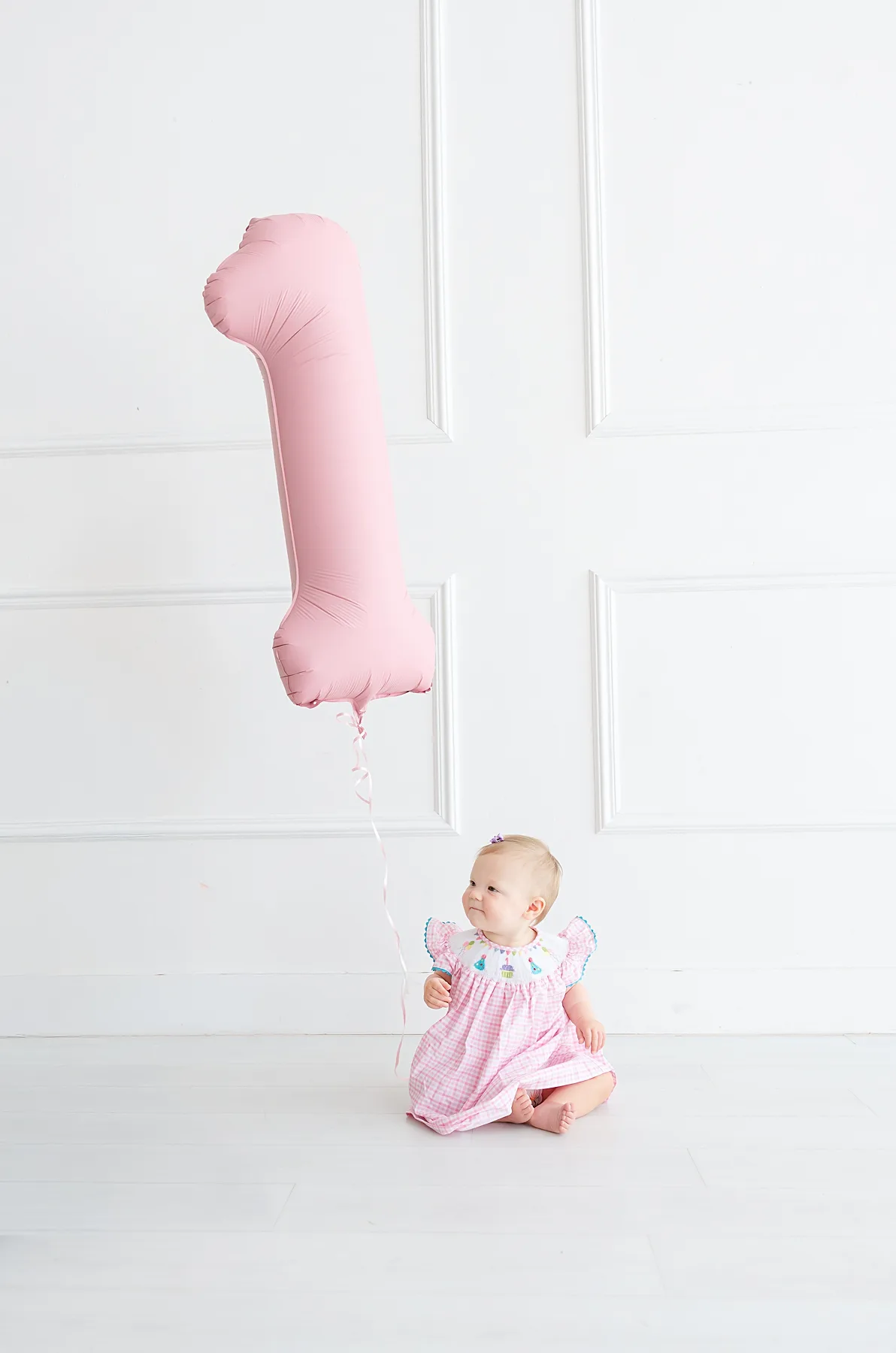 Little girl and pink one balloon for cake smash photo session in OKC.