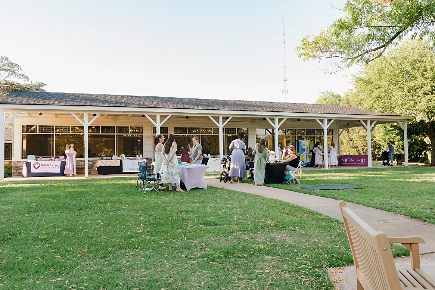 Ladies mingle on the lawn during an event at Elms and Oaks in Edmond, OK.