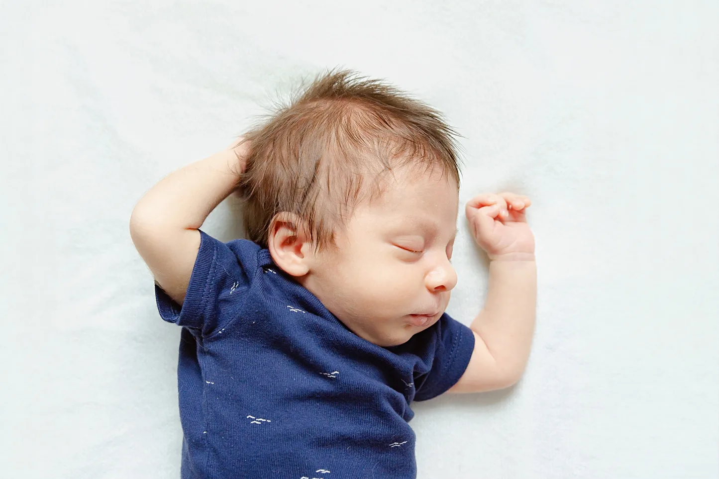 Big brother looks at baby during hospital newborn photos in Oklahoma City.